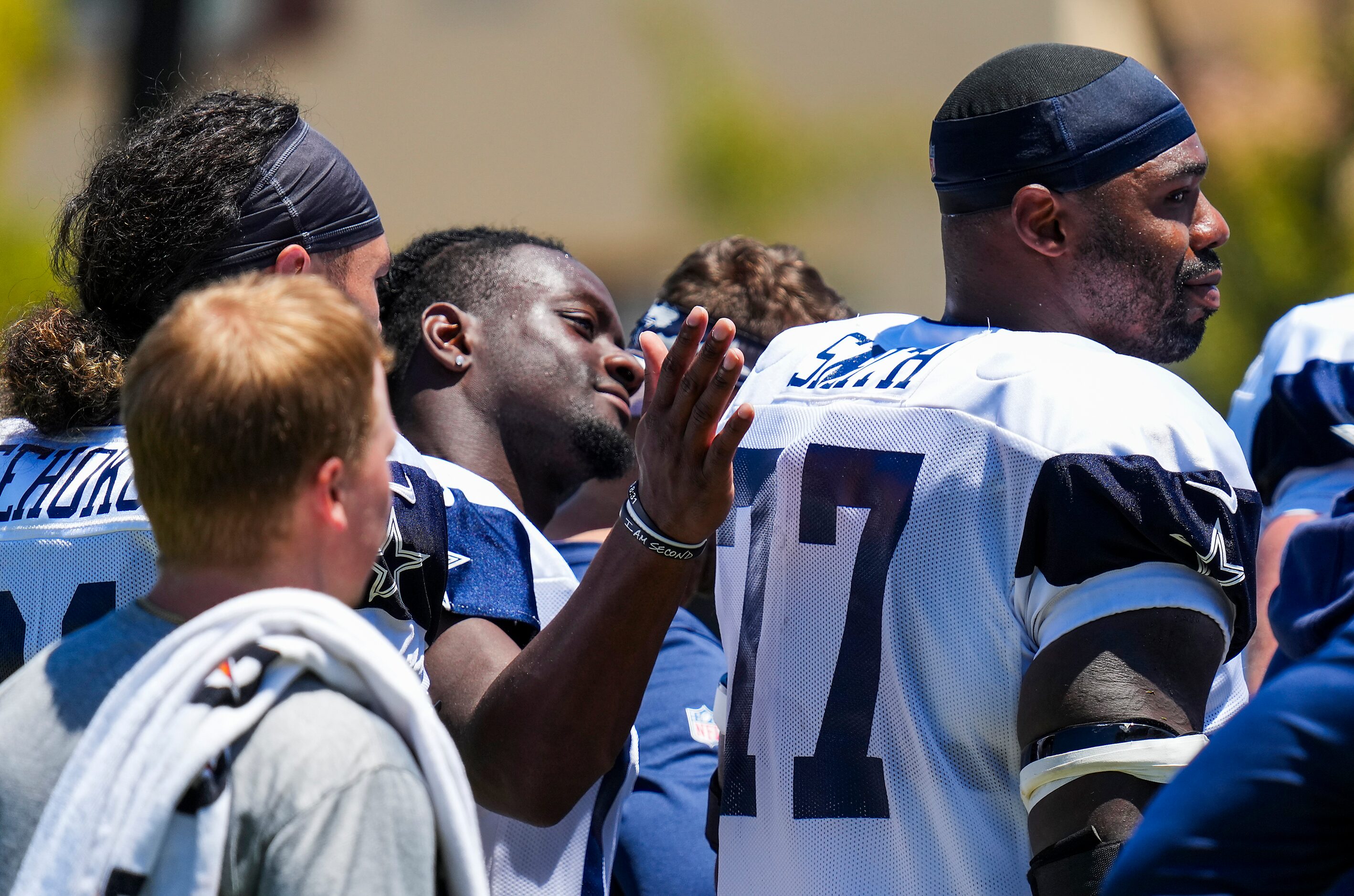 Dallas Cowboys offensive lineman Tyron Smith (77) gets a pat on the back from wide receiver...