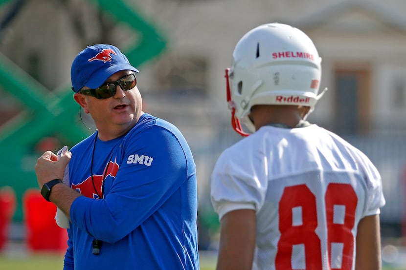 SMU head football coach Sonny Dykes, left, talks with wide receiver Joshua Shelmire during...