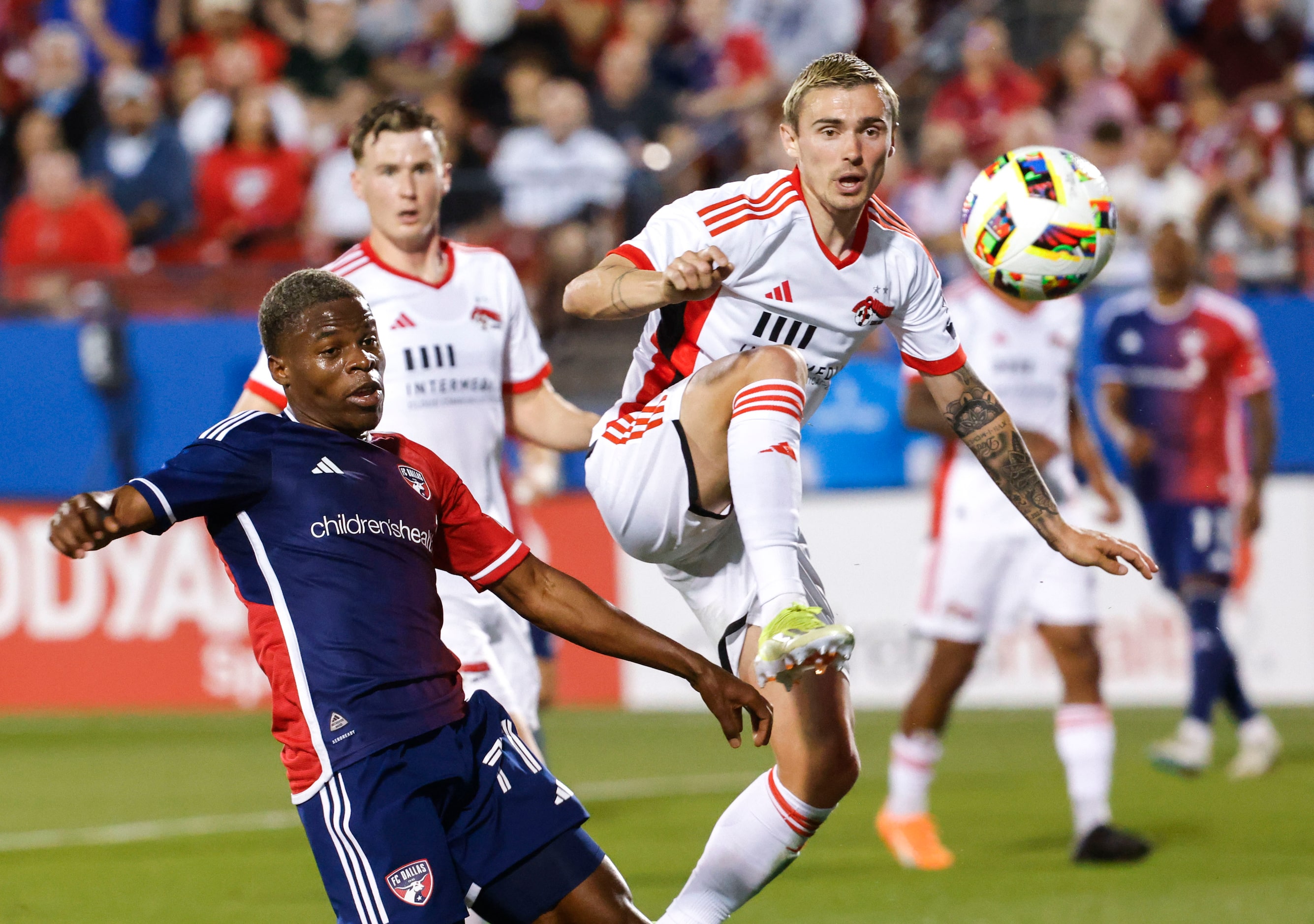 FC Dallas forward Bernard Kamungo (left) follows as San Jose defender Paul Marie takes away...