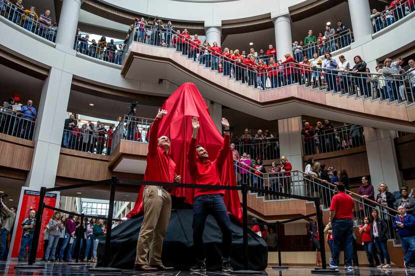 Johnathan Dagerath, left, and Michael Fountas, right, wave before unveiling the James Cash...