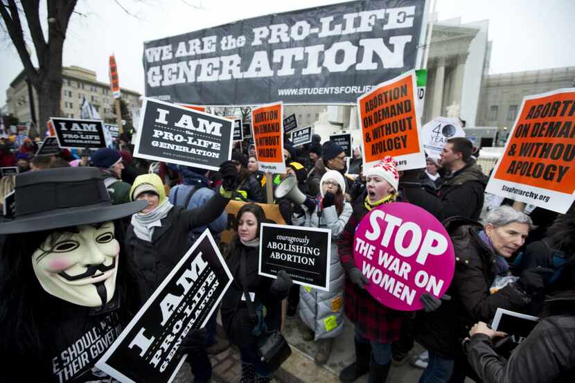 In this Jan. 25, 2013 file photo, pro-abortion rights activists, rally face-to-face against...