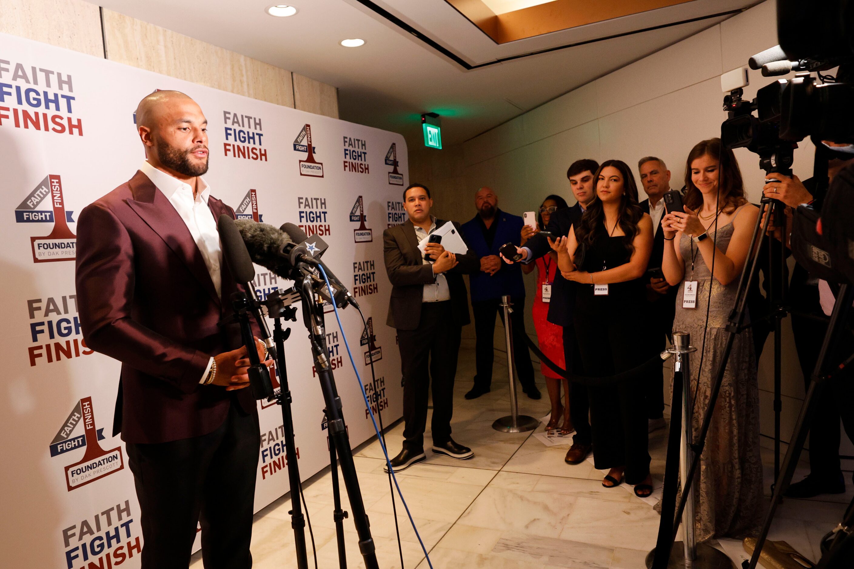 Dallas Cowboys quarterback Dak Prescott speaks to reporters during the Faith Fight Finish...