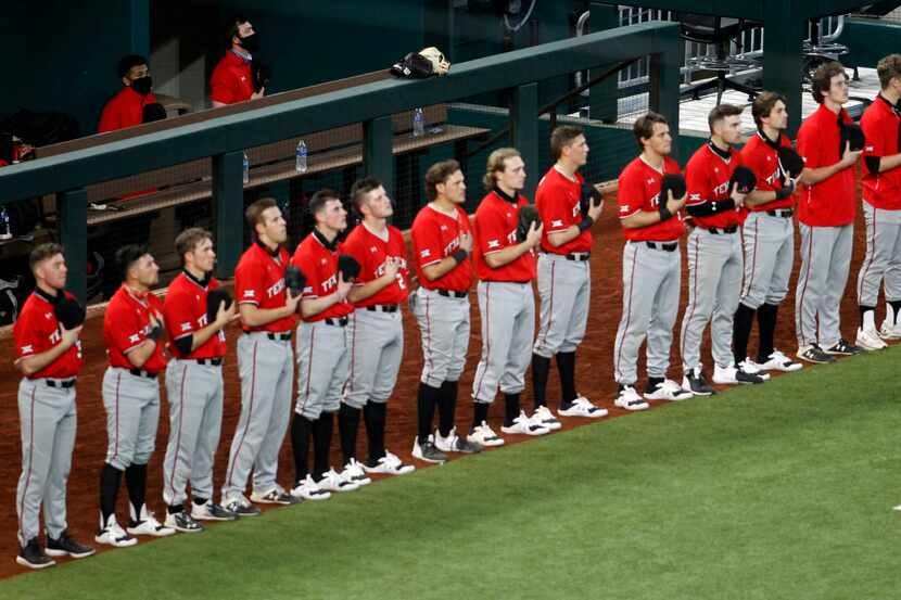 Members of the Texas Tech Red Raiders baseball team pause for the playing of the national...