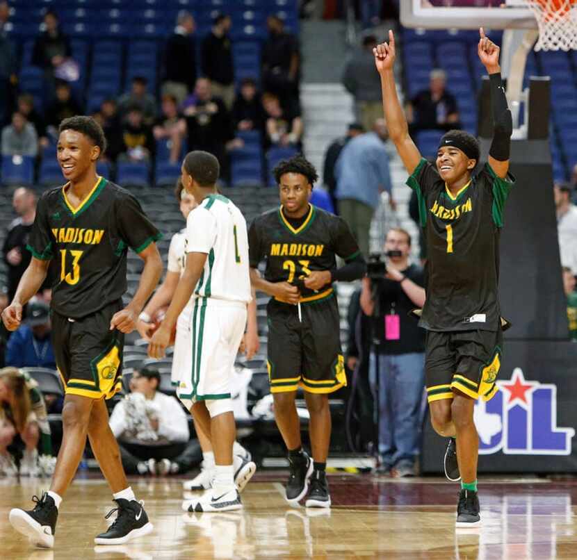 Madison's Dominique Robinson #1 and his teammates begins to celebrate as seconds tick off....