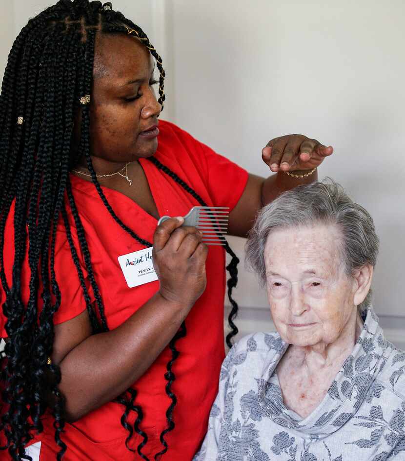 Ardent Hospice certified nursing assistant Tracey Gardener combs Iris Kerr's hair at The...