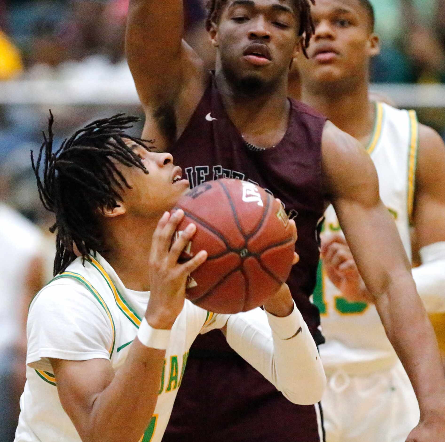 Madison High School guard Pierre Hunter (1) attempts a put back while Jefferson High School...