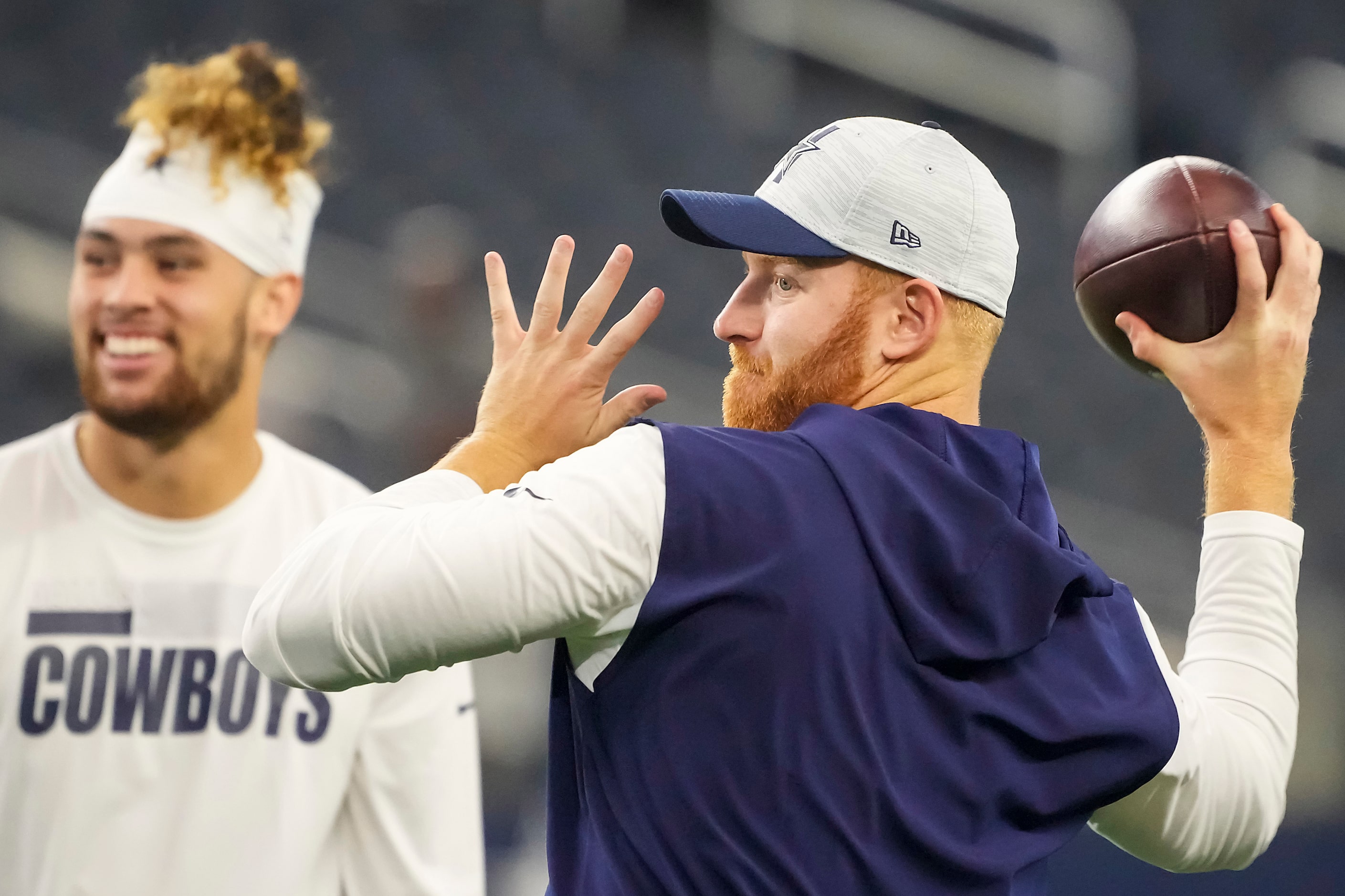 Dallas Cowboys quarterback Cooper Rush throws a pass as players warm up before a preseason...