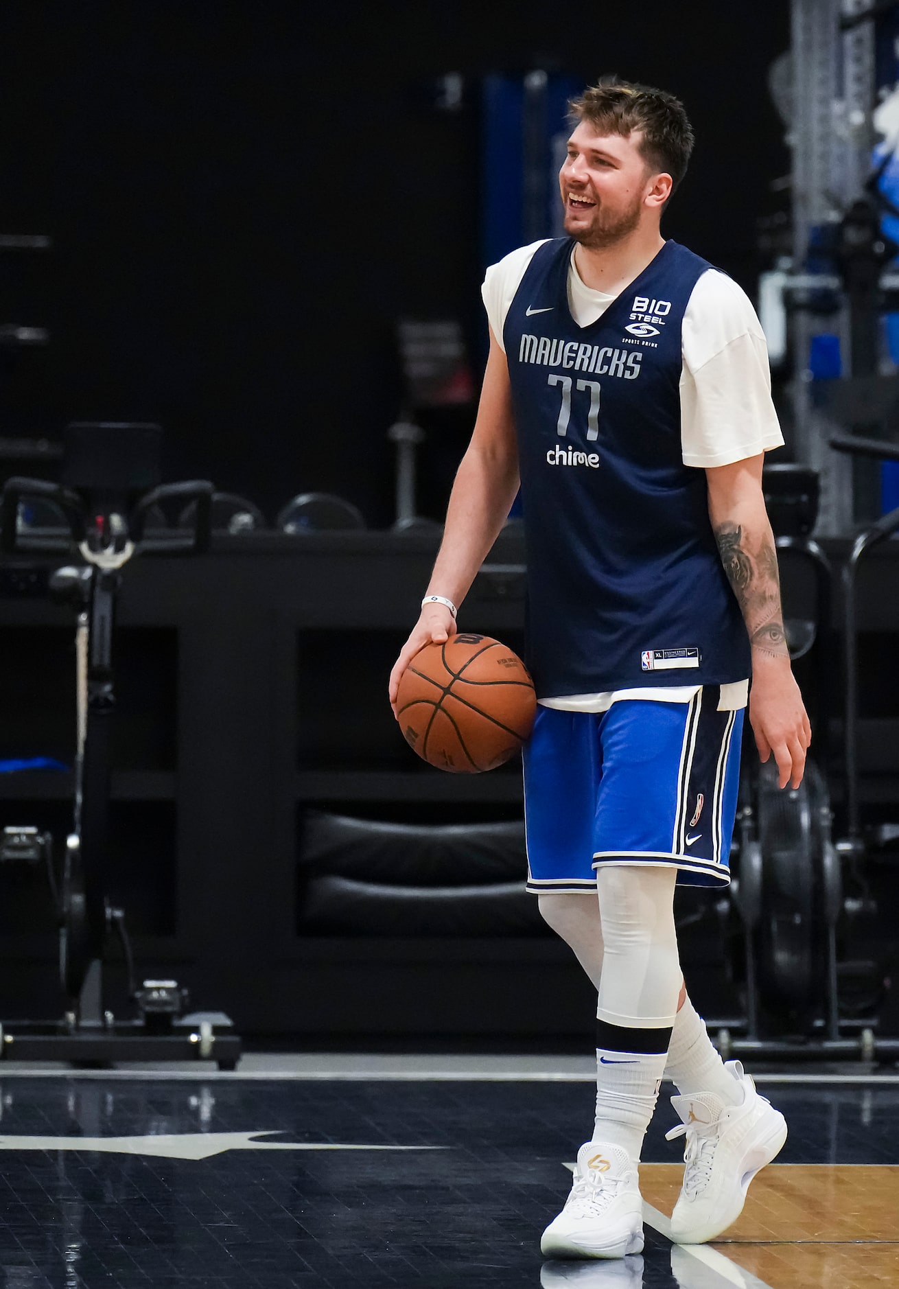 Dallas Mavericks guard Luka Doncic laughs with teammates as the team practices in...