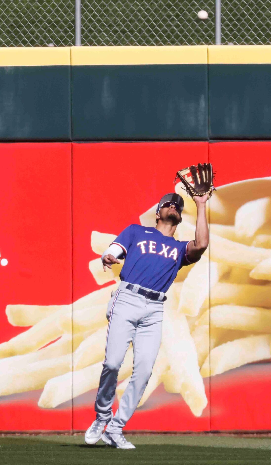 Texas Rangers center fielder Bubba Thompson catches a ball hit by Cincinnati Reds Noelvi...