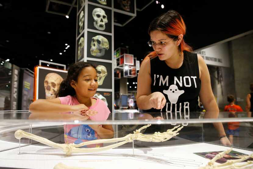 Sylvia Rodriguez, 9, and her mother Janet Rodriguez of Spring check out an exhibit at the...