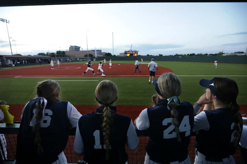 Flower Mound High School players cheer on their team during a softball game against Allen...
