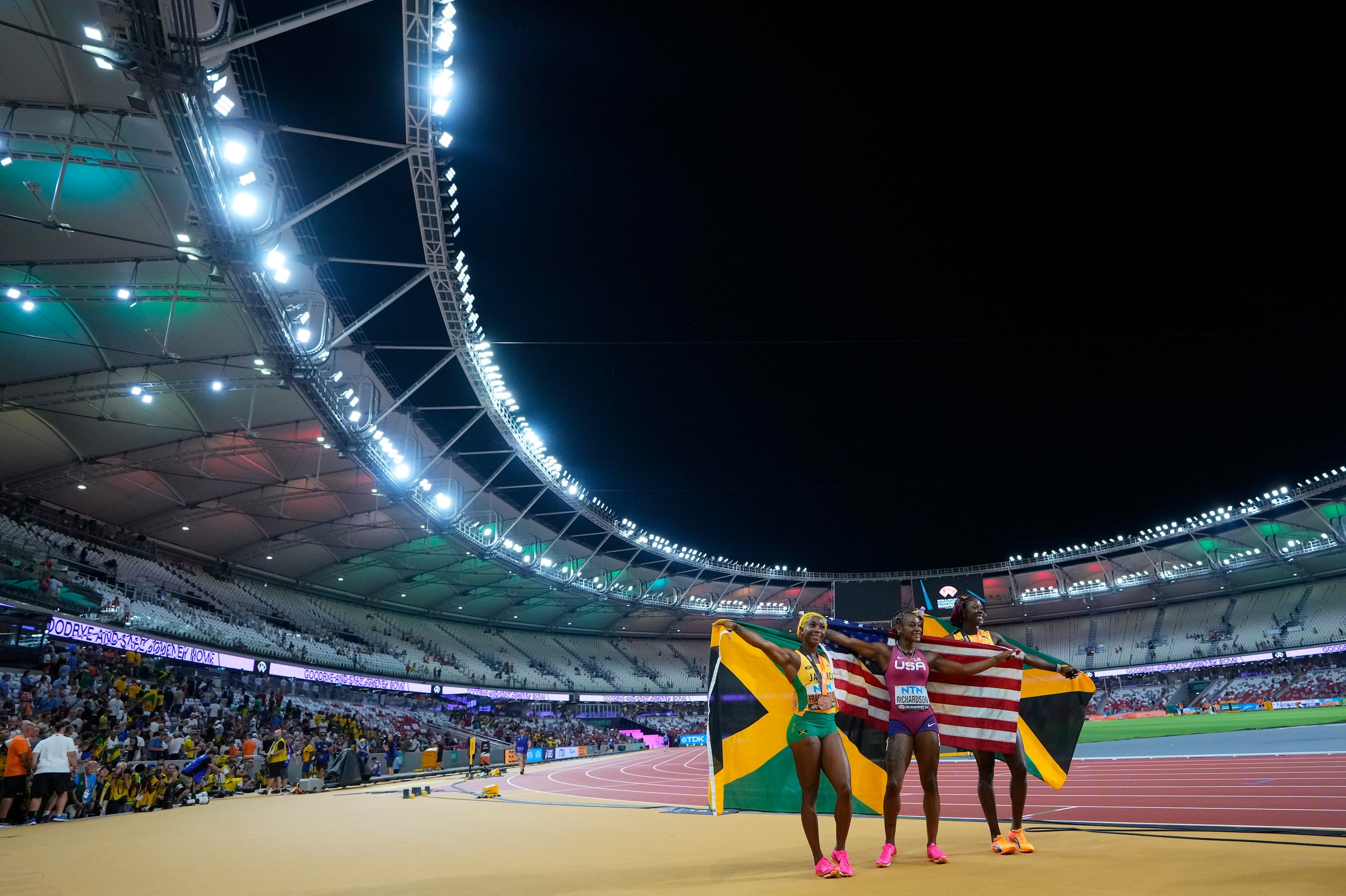 Silver medalist Sharicka Jackson of Jamaica, right, gold medalist Sha'Carri Richardson of...