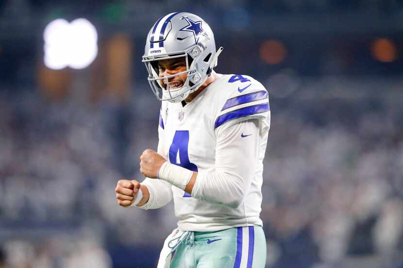 FILE - Cowboys quarterback Dak Prescott (4) reacts after receiver Michael Gallup (13) scored...