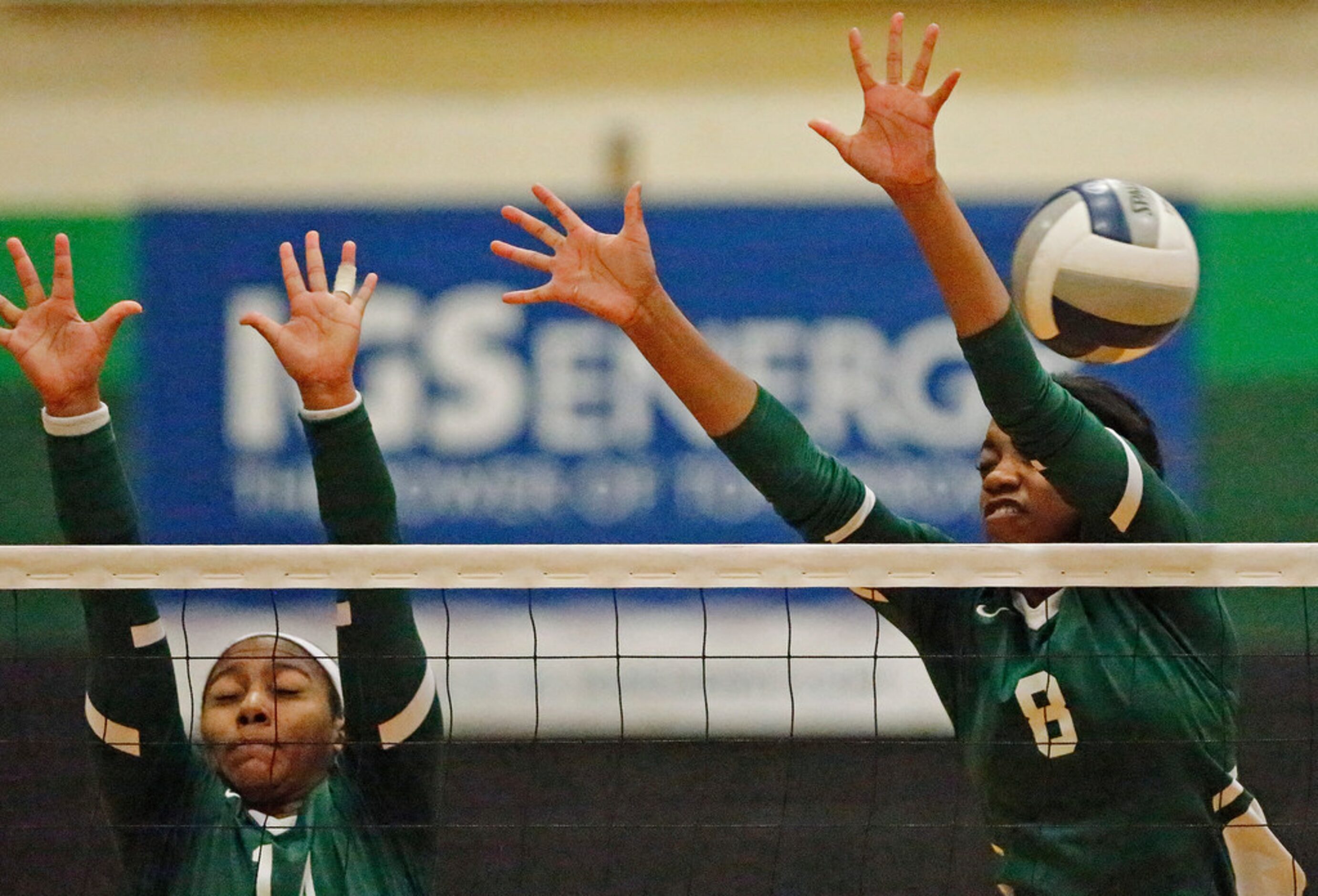 Lebanon Trail High School outside hitter Rayna Williams (14) and Lebanon Trail High School...