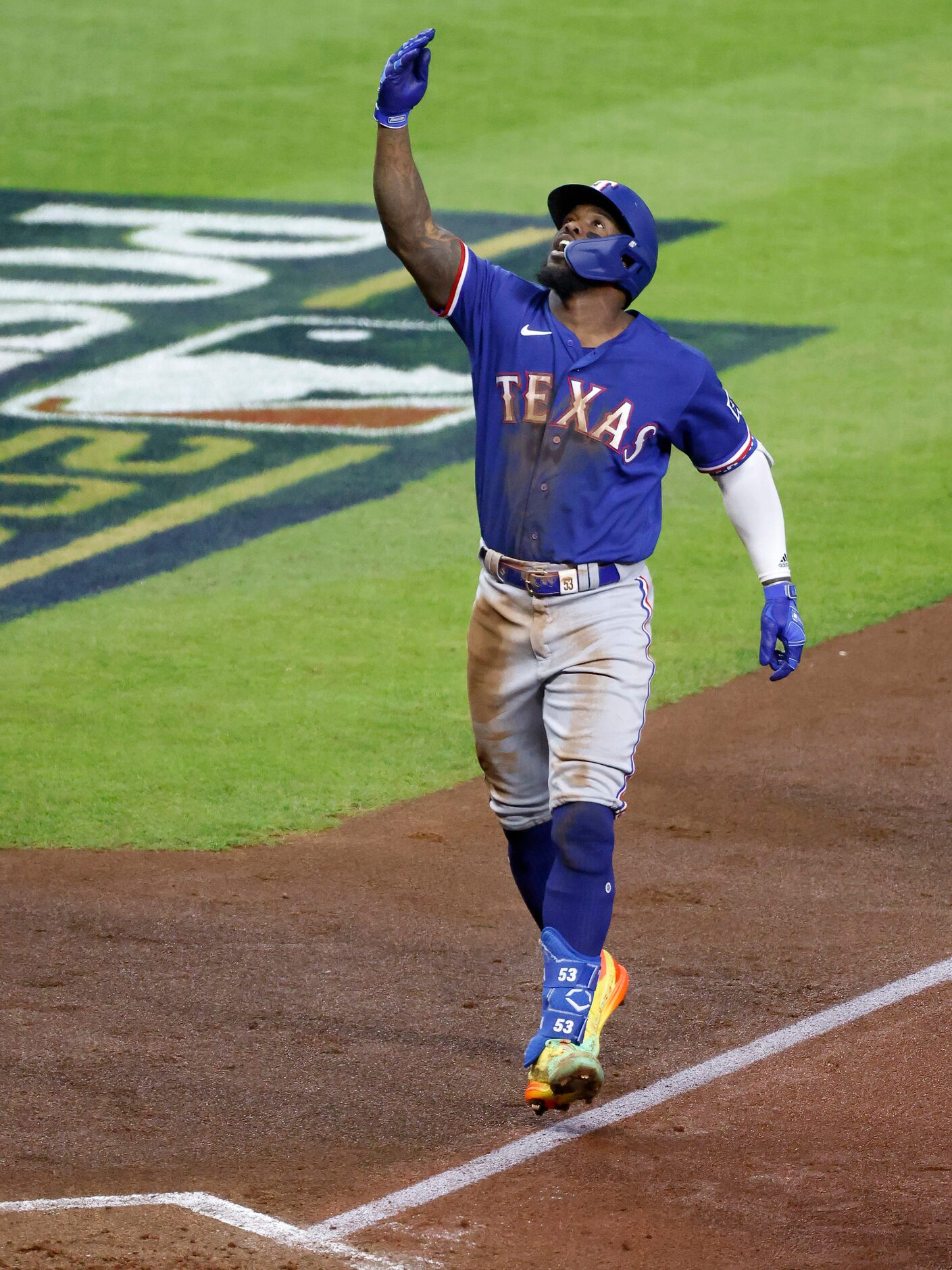 Texas Rangers Adolis Garcia (53) points skyward as he approaches home plate following his...