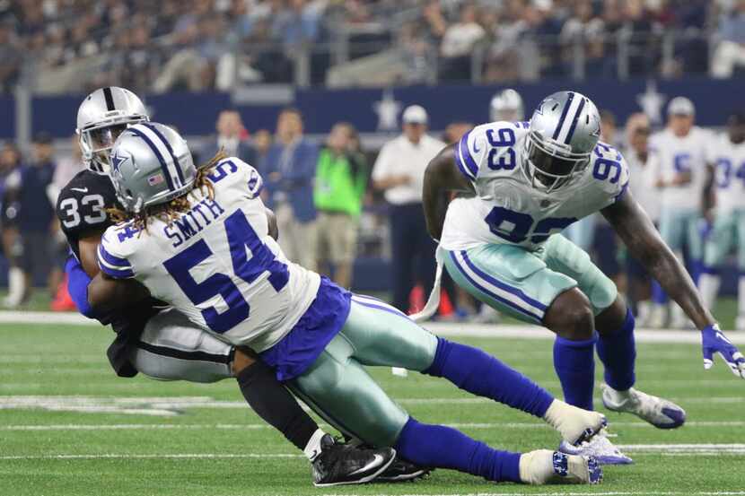 Dallas Cowboys  Jaylon Smith (54 ) tackles Oakland Raiders  DeAndre Washington (33) during...