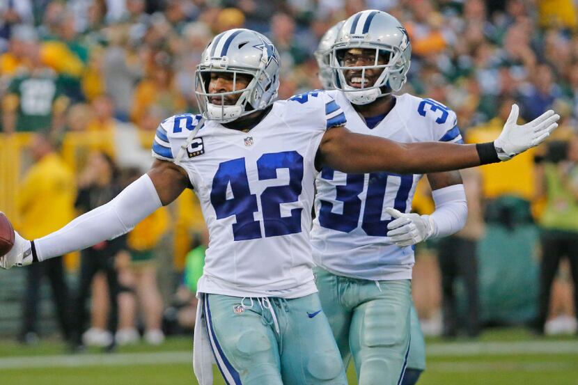 Dallas Cowboys strong safety Barry Church (42) celebrates his interception with teammate...