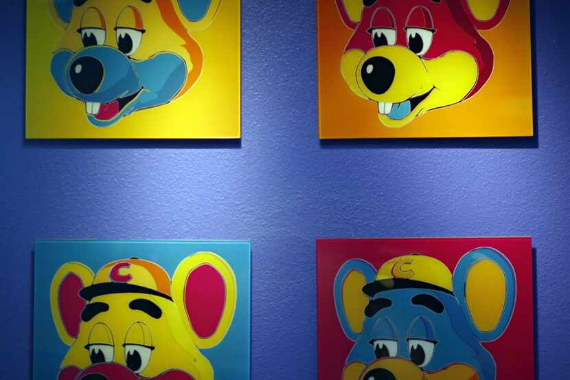 Paintings hang on a wall at Chuck E. Cheese's Thursday, January 16, 2014 in north Dallas....