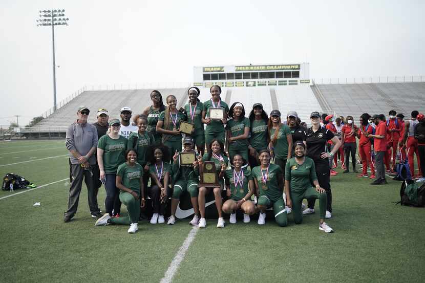 The DeSoto girls celebrate winning the team championship at the District 11-6A meet Friday....