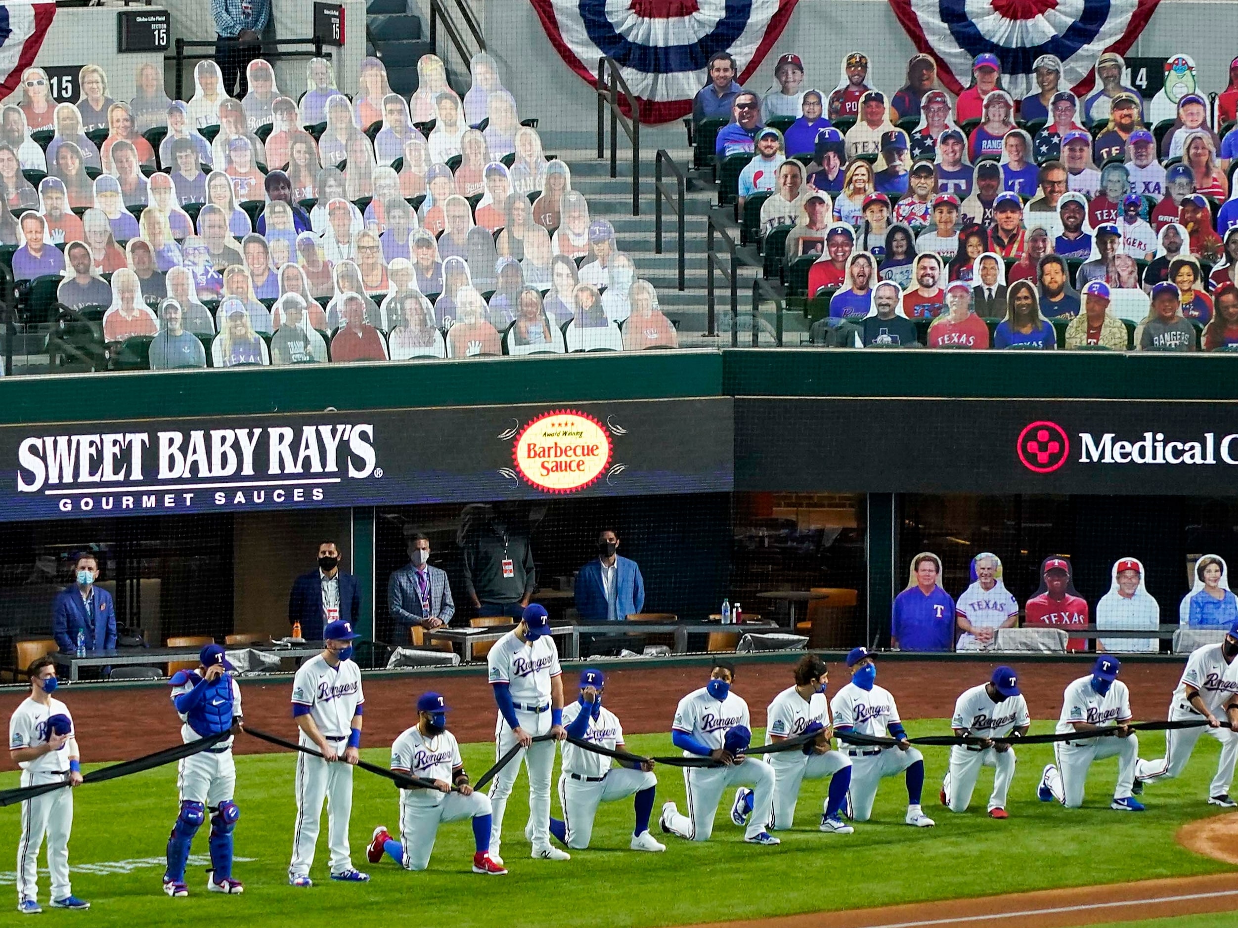 In front of a sea of cutout photos, sold as 
ÒDoppel RangersÓ filling the empty seats Texas...