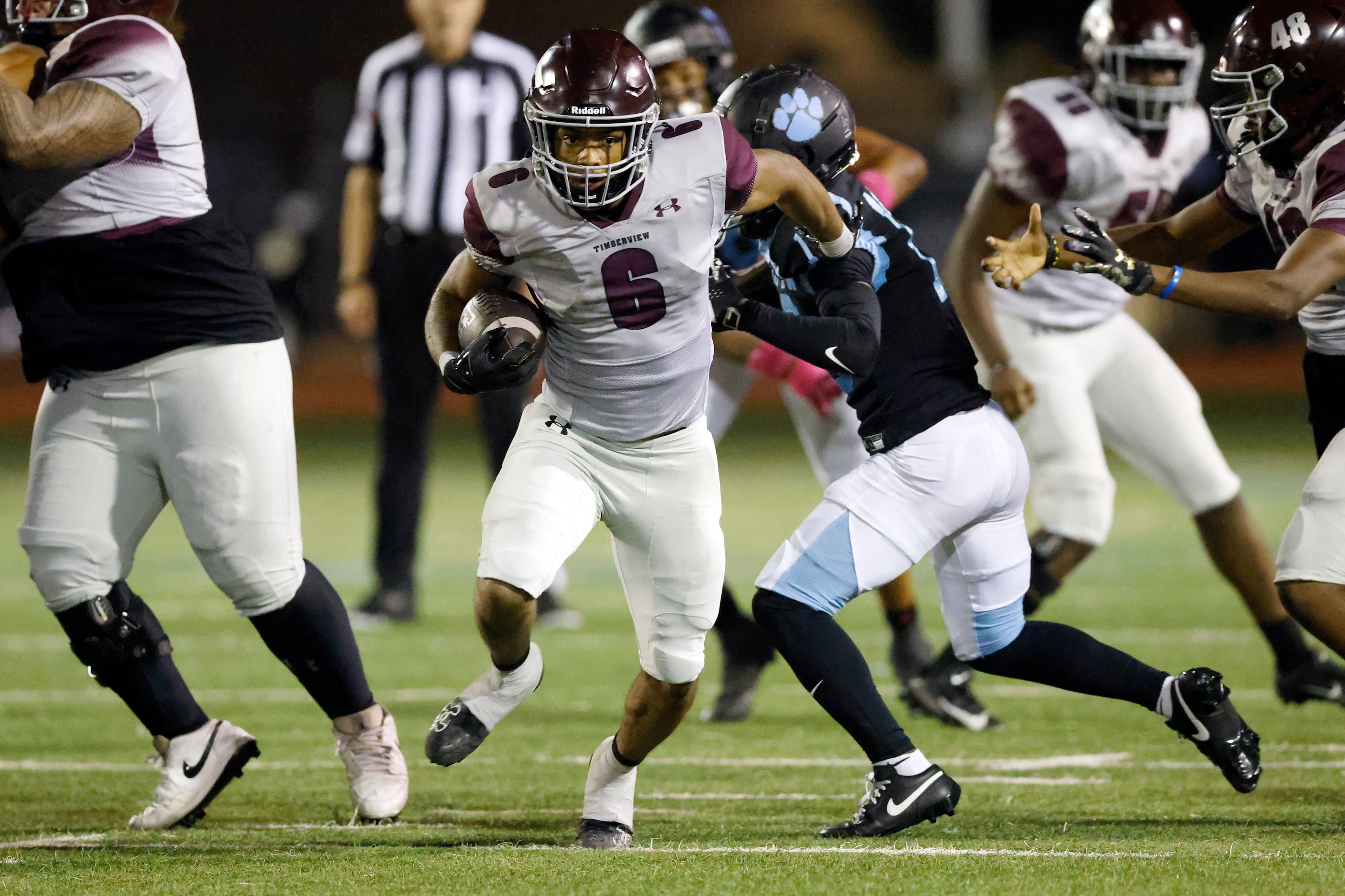 Mansfield Timberview running back Jaylon Woods (6) breaks through the line of scrimmage as...