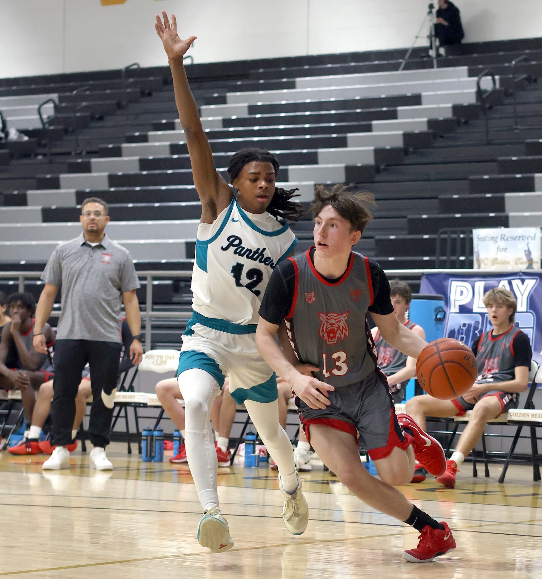 Dallas Woodrow Wilson's Michael Best (13), right, drives the baseline as he is defended by...