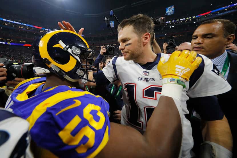 ATLANTA, GA - FEBRUARY 03:  Tom Brady #12 of the New England Patriots hugs Samson Ebukam #50...