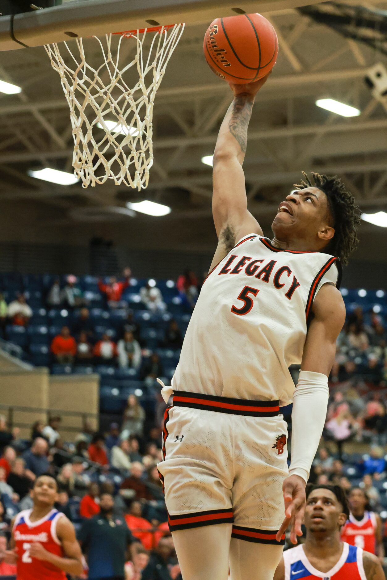 Mansfield Legacy High School’s Ahmare Rose (5) dunks during a game against Duncanville High...