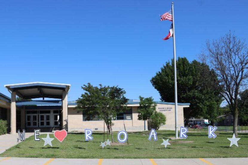 Decorations grace the lawn of Roark Elementary School in East Arlington on the last day of...
