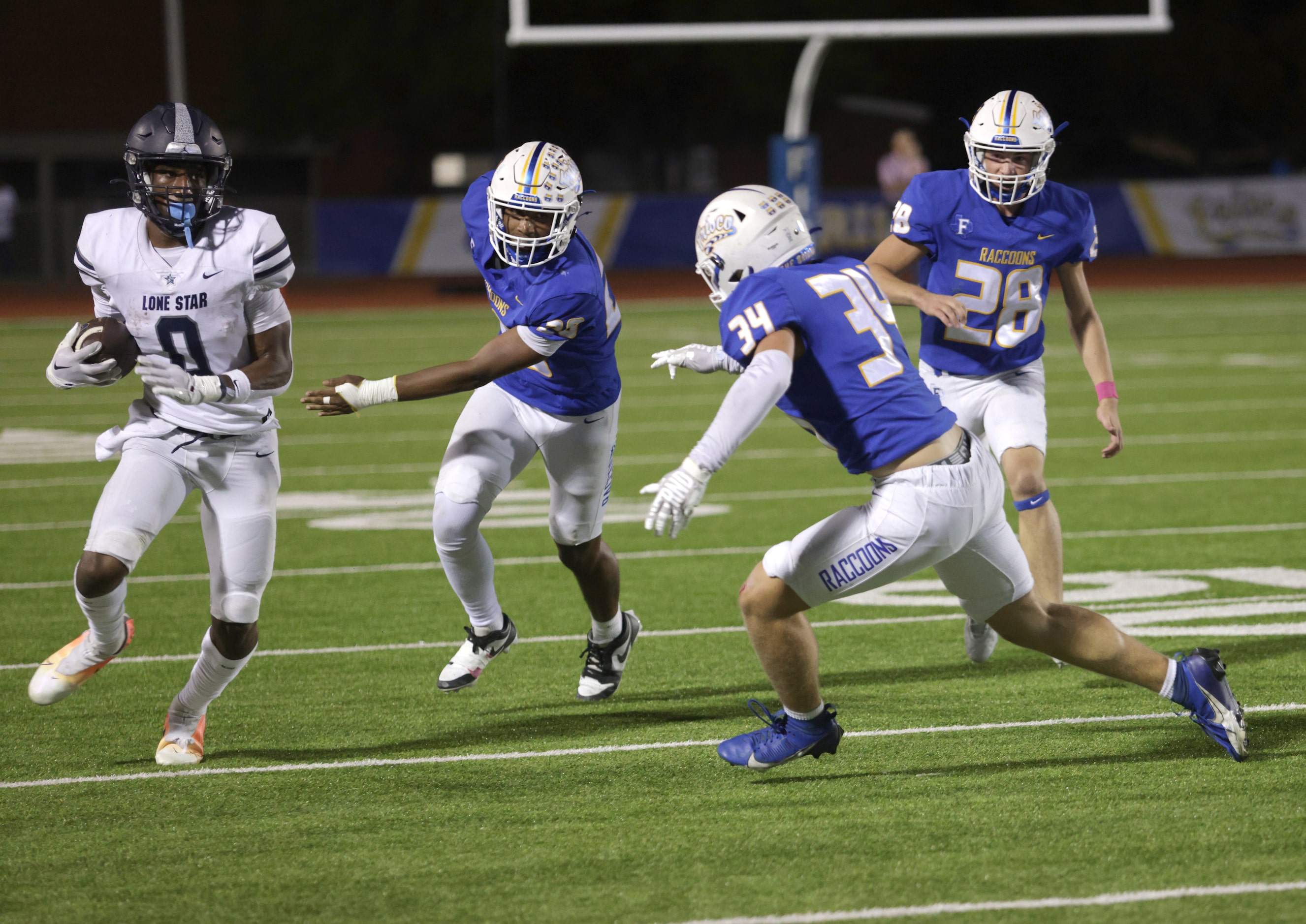 Lone Star player #0 Davian Groce avoids a tackle during the Frisco Lone Star High School...