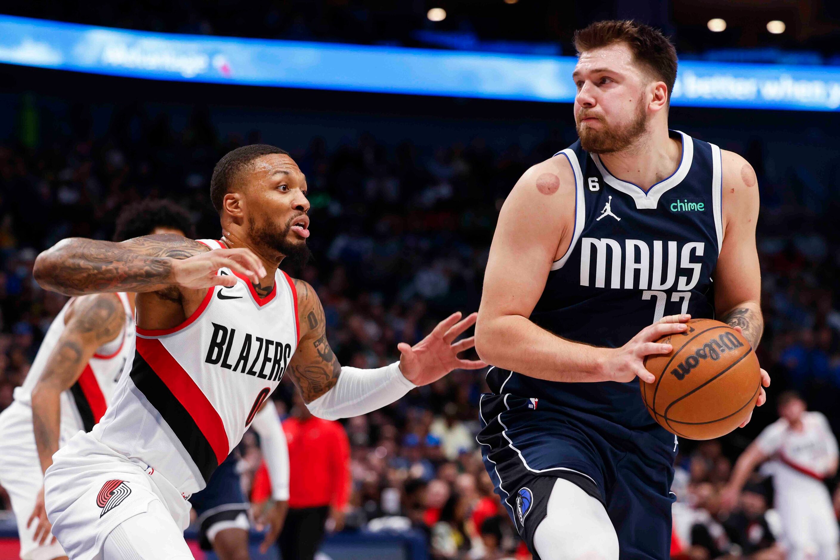 Dallas Mavericks guard Luka Doncic (77) looks to pass past Portland Trail Blazers guard...