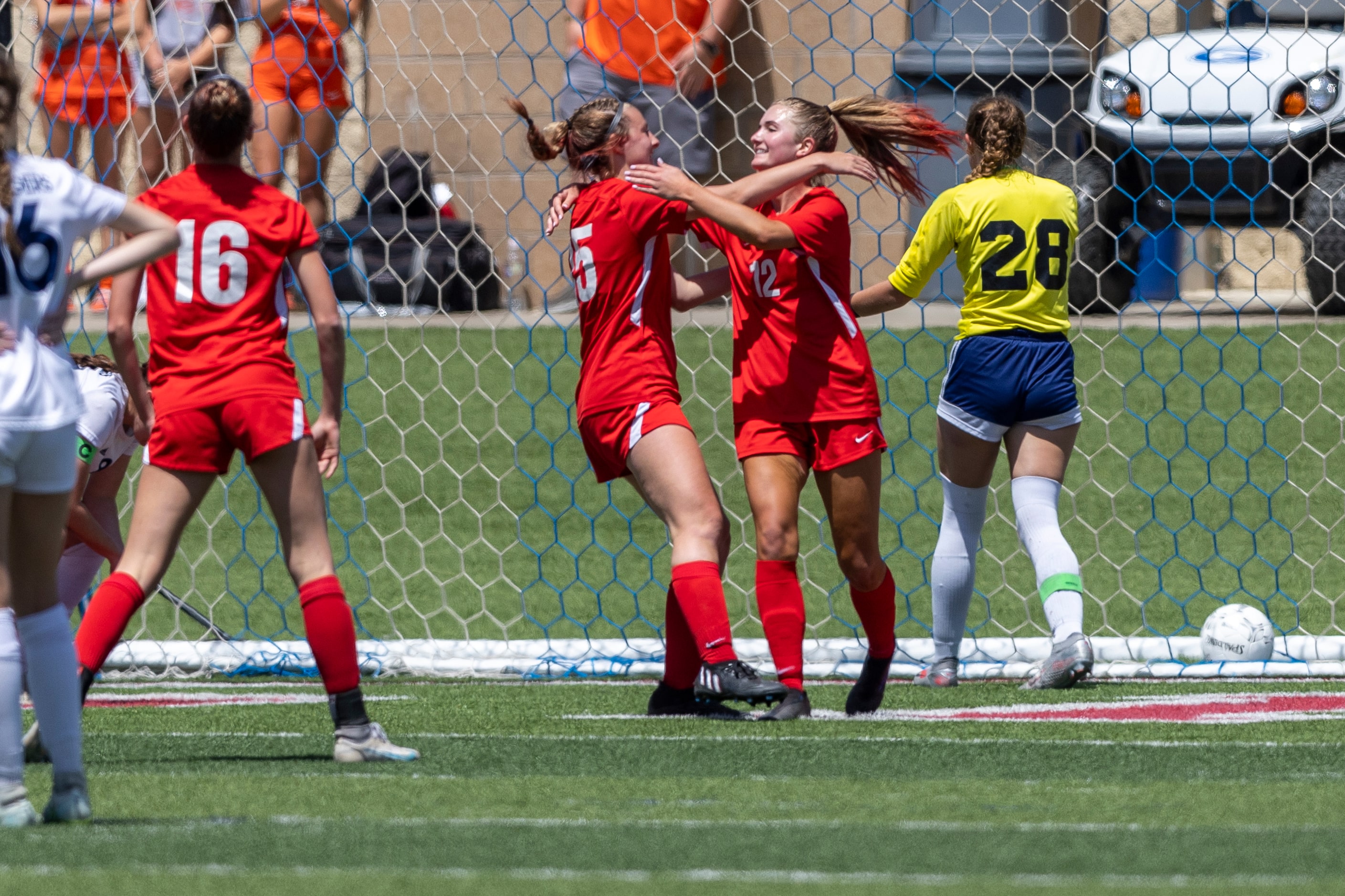 Grapevine midfielder Caroline Martin, left, celebrates the goal of forward Samantha Larsen...