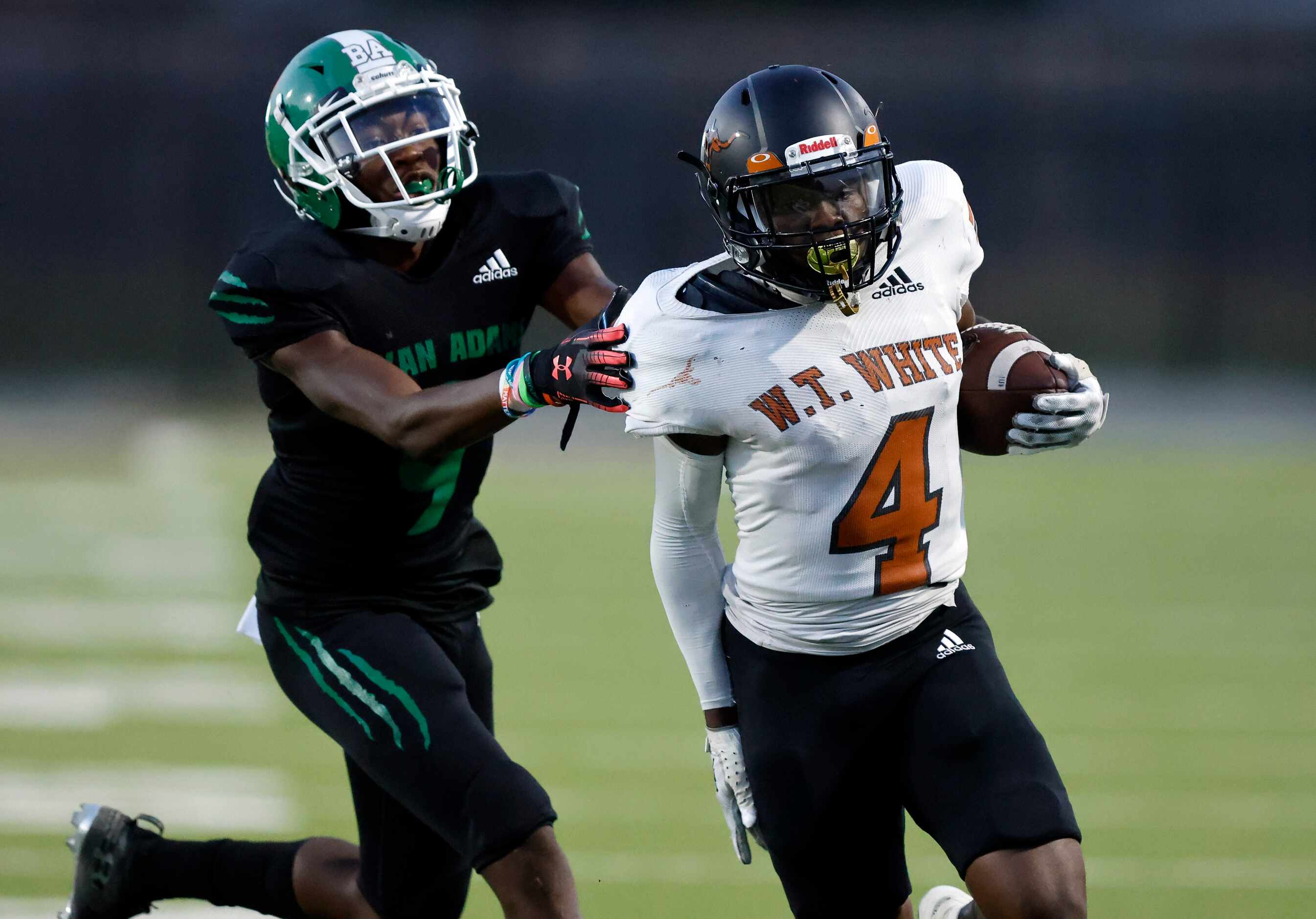 W.T. White’s Justin Joof (4) carries the ball as he’s pursued by Bryan Adams Altrie Farris...