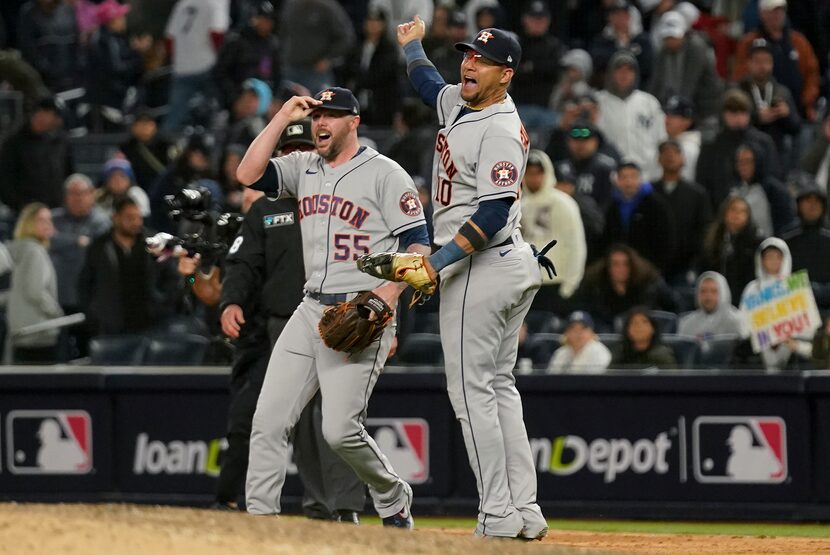 Houston Astros relief pitcher Ryan Pressly (55) and first baseman Yuli Gurriel (10)...