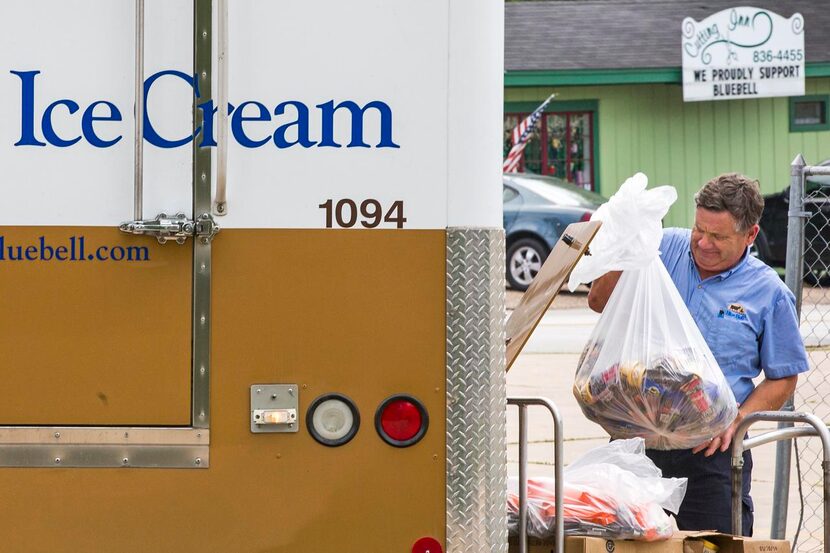 
A Blue Bell employee loads recalled ice cream into a truck at a convenience store in...