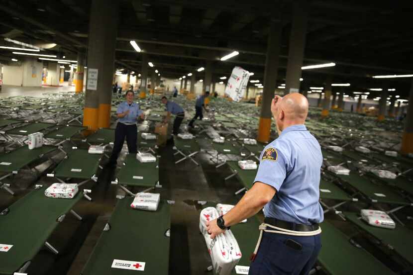 Dallas Fire-Rescue recruit David Manning tossed American Red Cross blankets onto beds to...