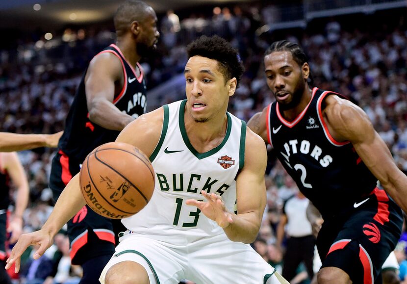 Milwaukee Bucks guard Malcolm Brogdon (13) receives a pass as Toronto Raptors forward Kawhi...