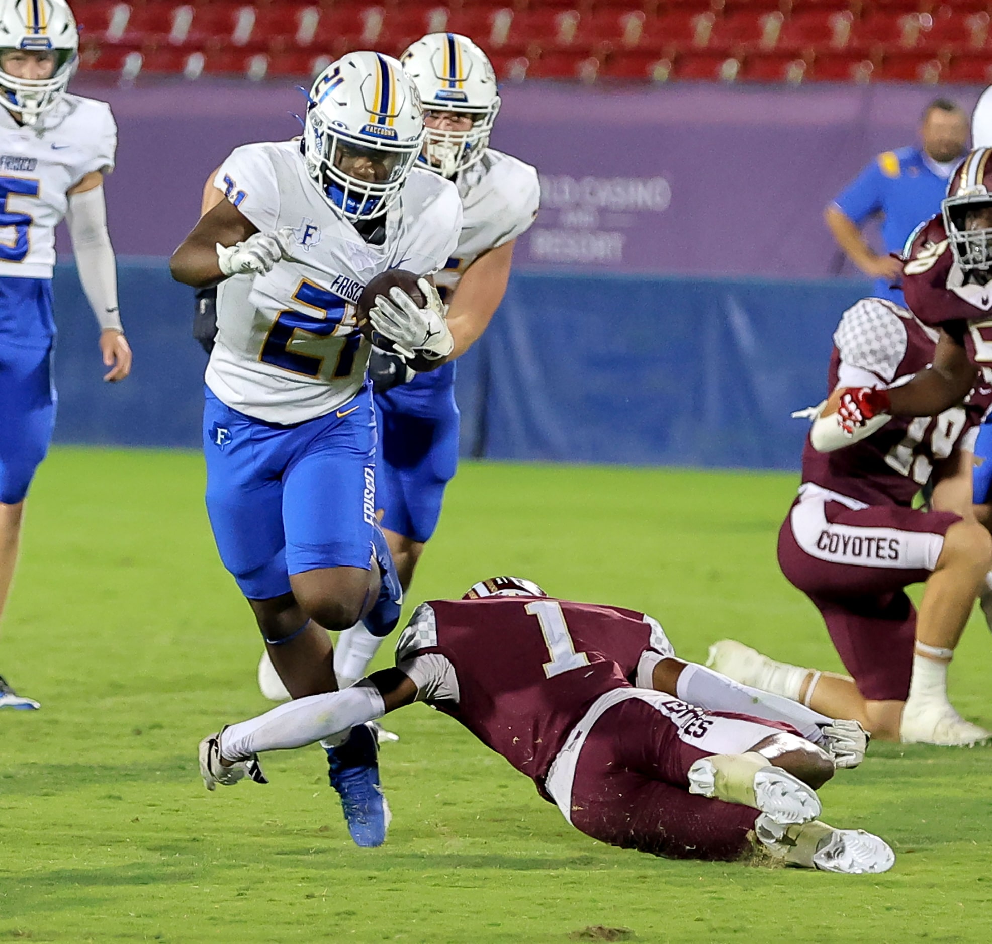 Frisco running back David Nickerson (21) tries to run past Frisco Heritage defensive back...