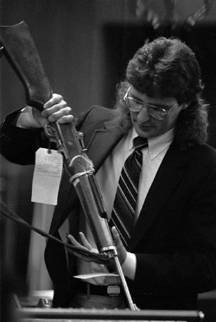 David Koresh during a 1988 court appearance with one of the weapons used in a 1987 shootout...