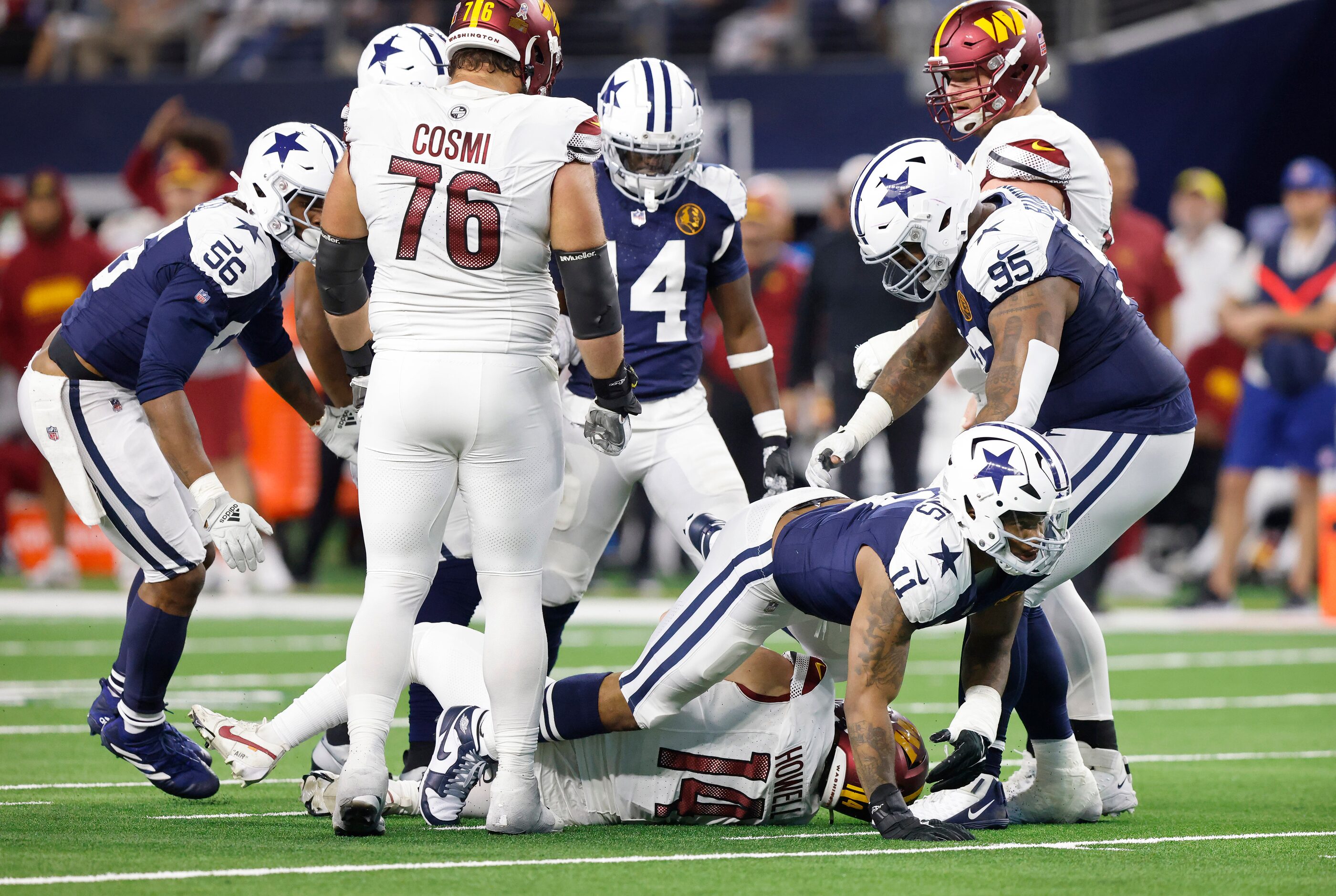 Dallas Cowboys linebacker Micah Parsons (11) crawls off of Washington Commanders quarterback...