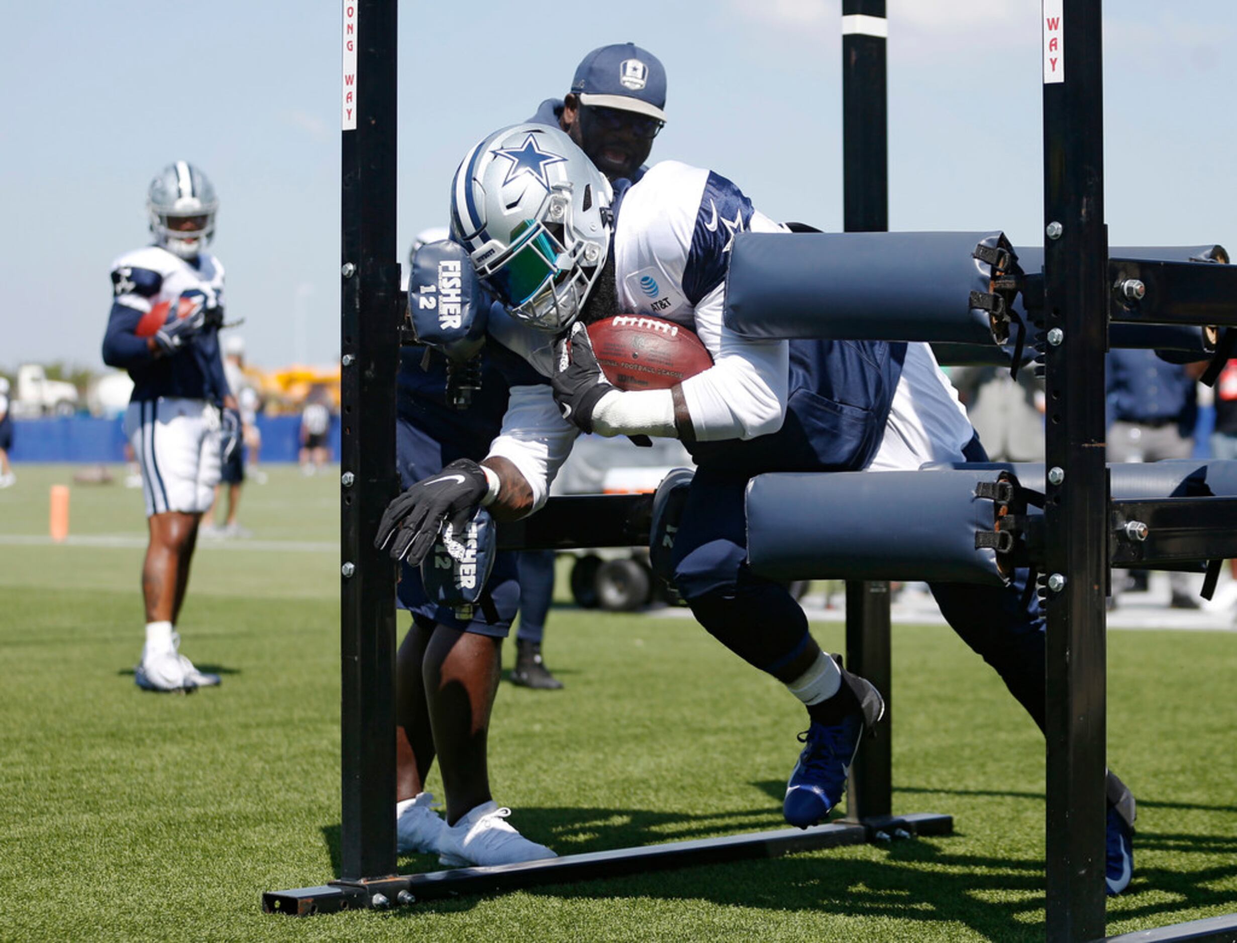 Dallas Cowboys running back Ezekiel Elliott (21) runs through drills with Dallas Cowboys...