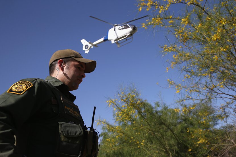 MISSION, TX - APRIL 11:  A U.S. Border Patrol agent guards a suspected drug smuggler caught...