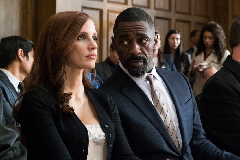 This image released by STXfilms shows Idris Elba, right, and Jessica Chastain in a scene...