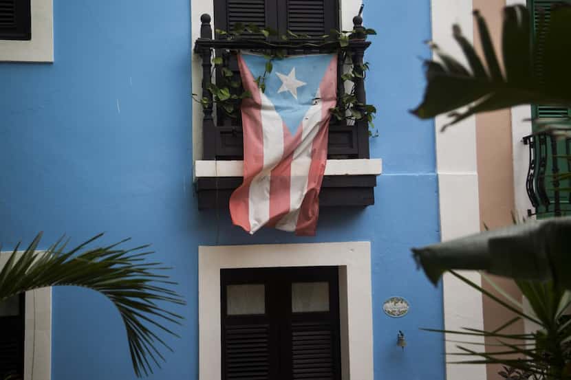
A Puerto Rican flag hangs from the balcony of a house in San Juan on May 1. (MUST CREDIT:...
