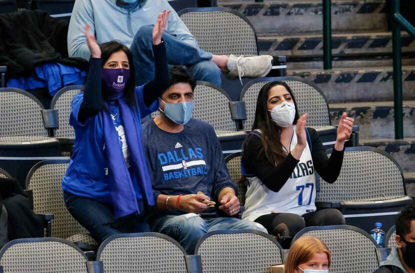 Parkland Dr. Manjula Julka, left, cheers on the Dallas Mavericks during the first half of an...