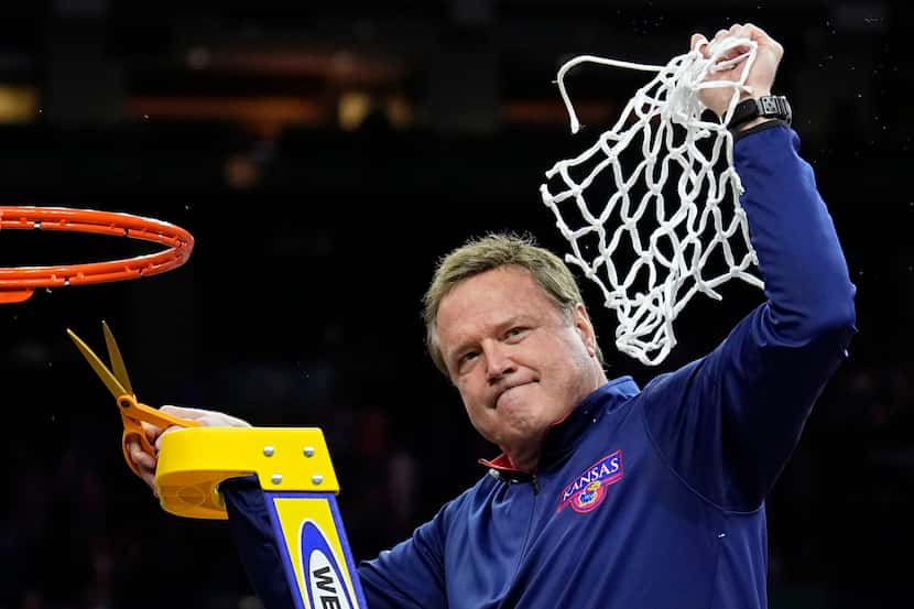 Kansas head coach Bill Self cuts the net after their win against North Carolina in a college...