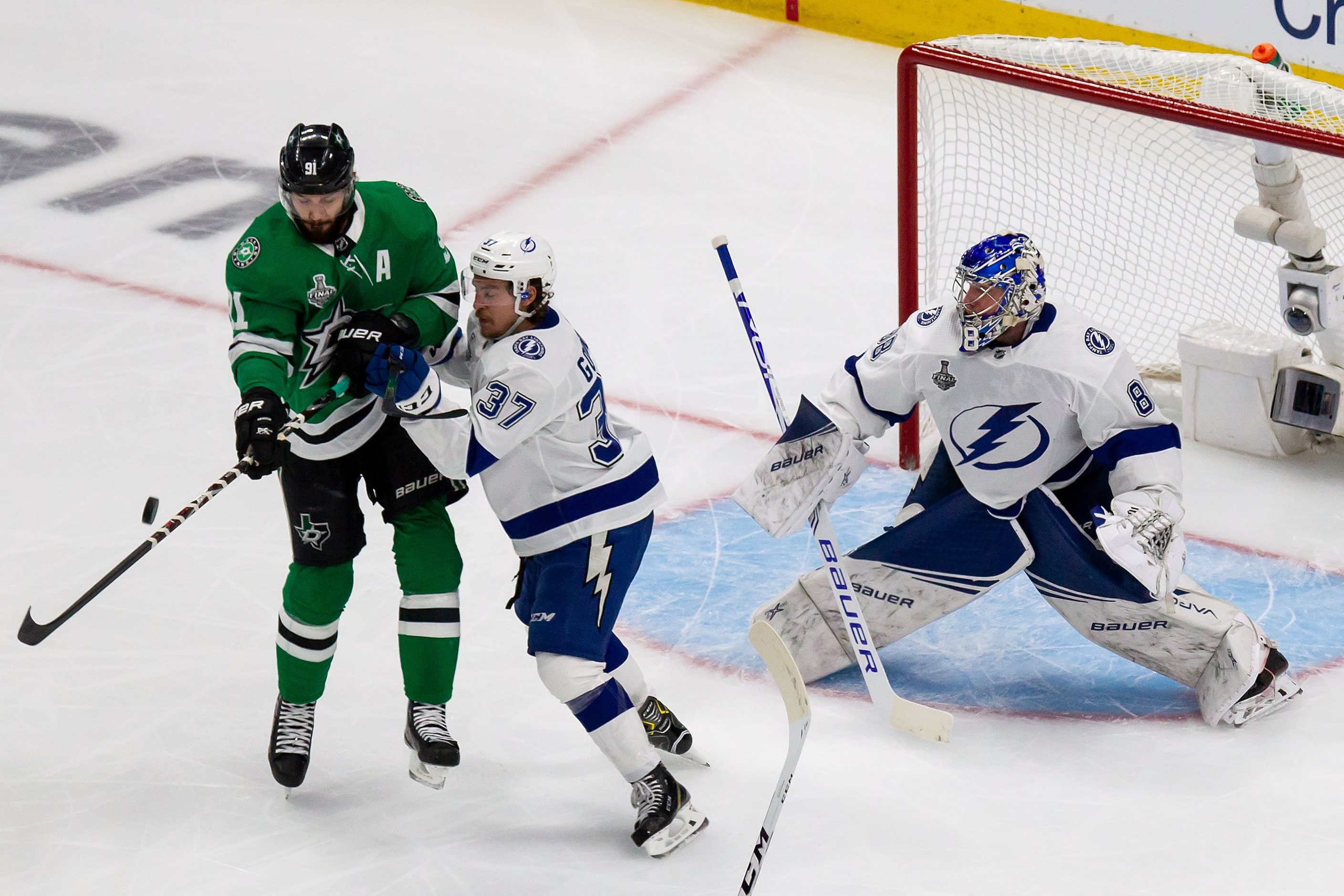 Tyler Seguin (91) of the Dallas Stars battles against Yanni Gourde (37) and goaltender...