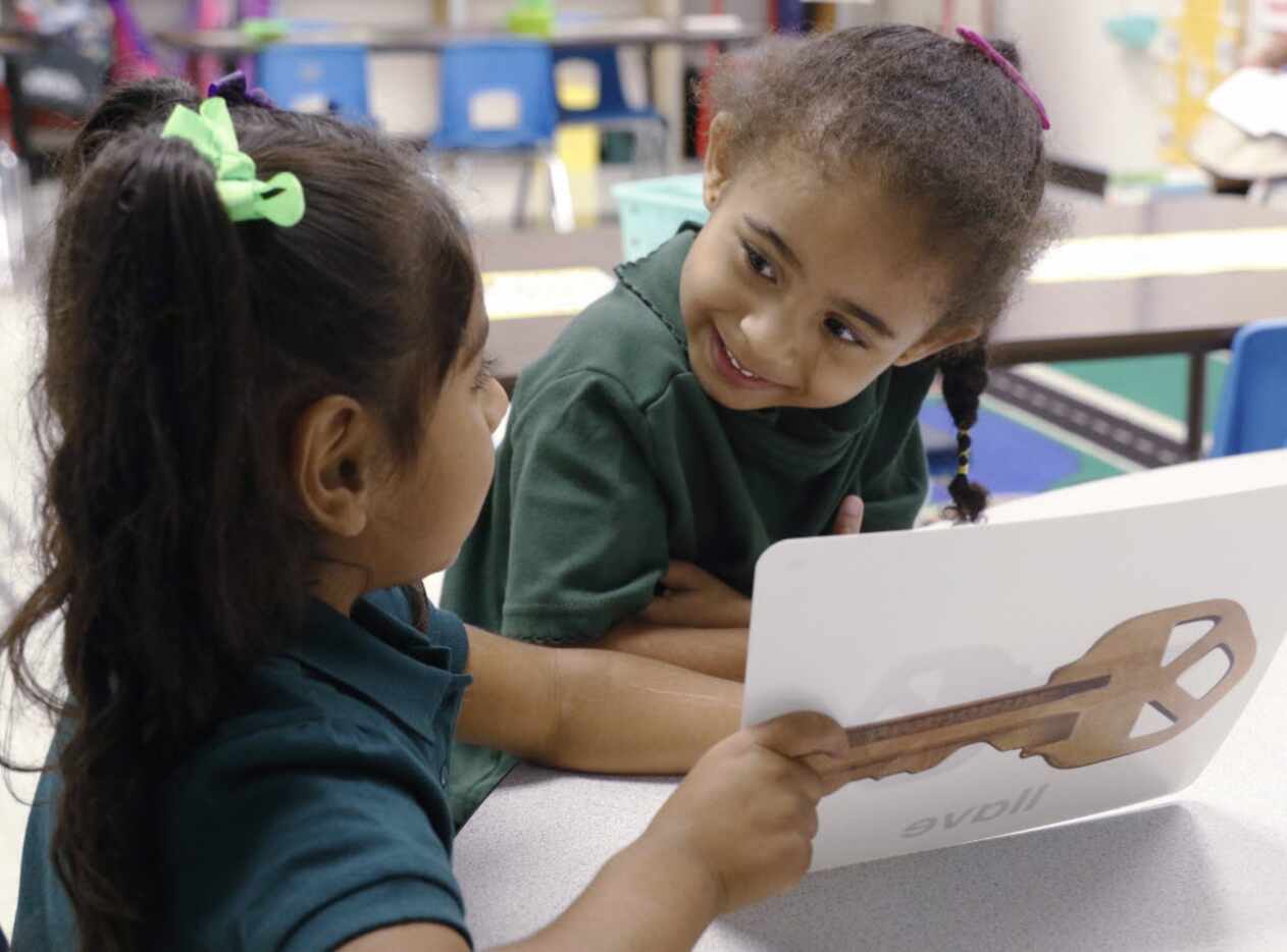 Orianna Hernandez, 5, left, and Felicia Hopson, 5, works on their vocabulary development in...