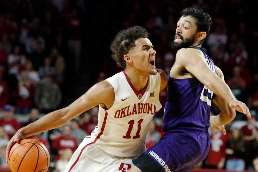 Oklahoma's Trae Young (11) drives the ball against TCU's Alex Robinson (25) during the...