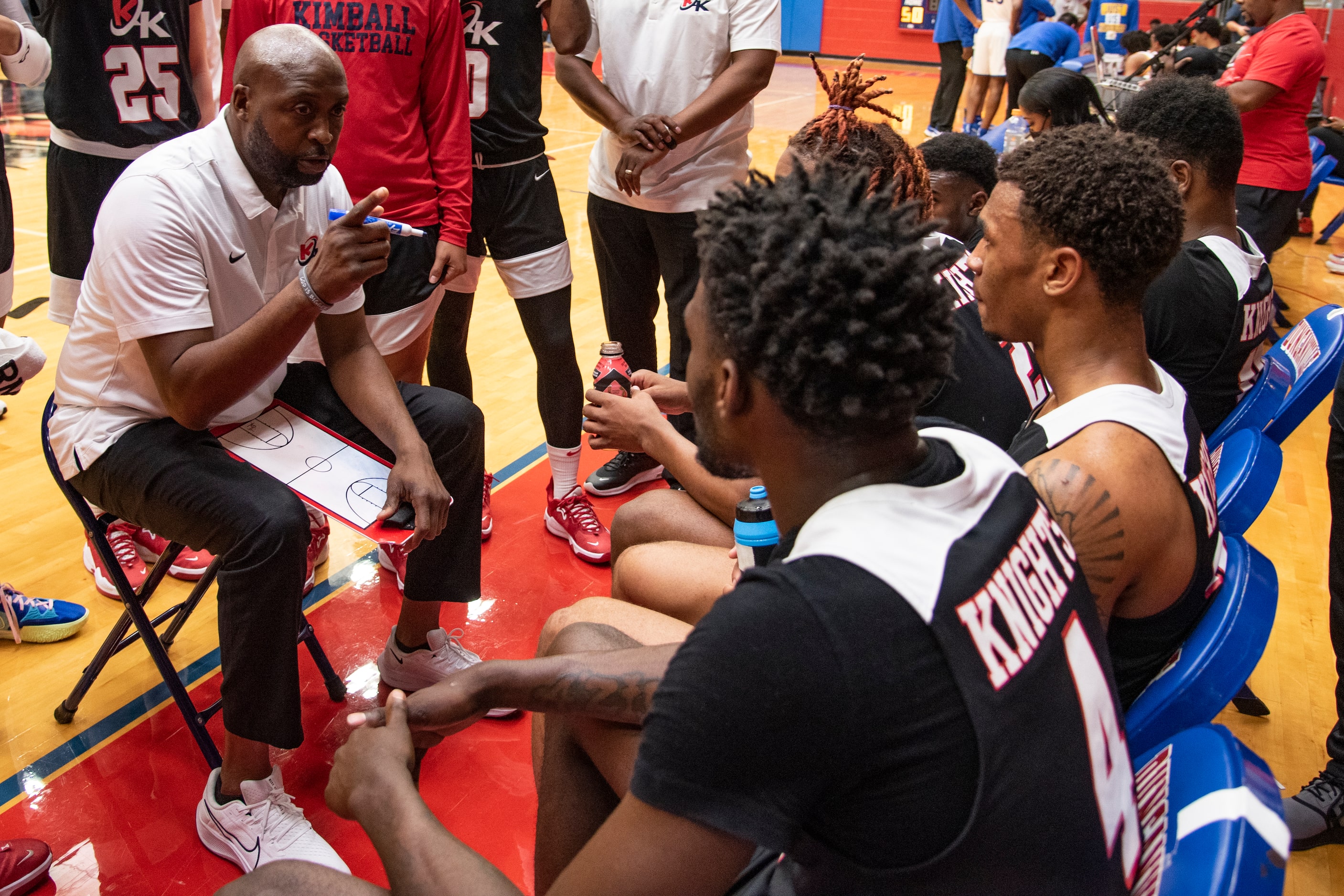 Kimball Head Coach Nick Smith talks to his players during a timeout at Kimball's...